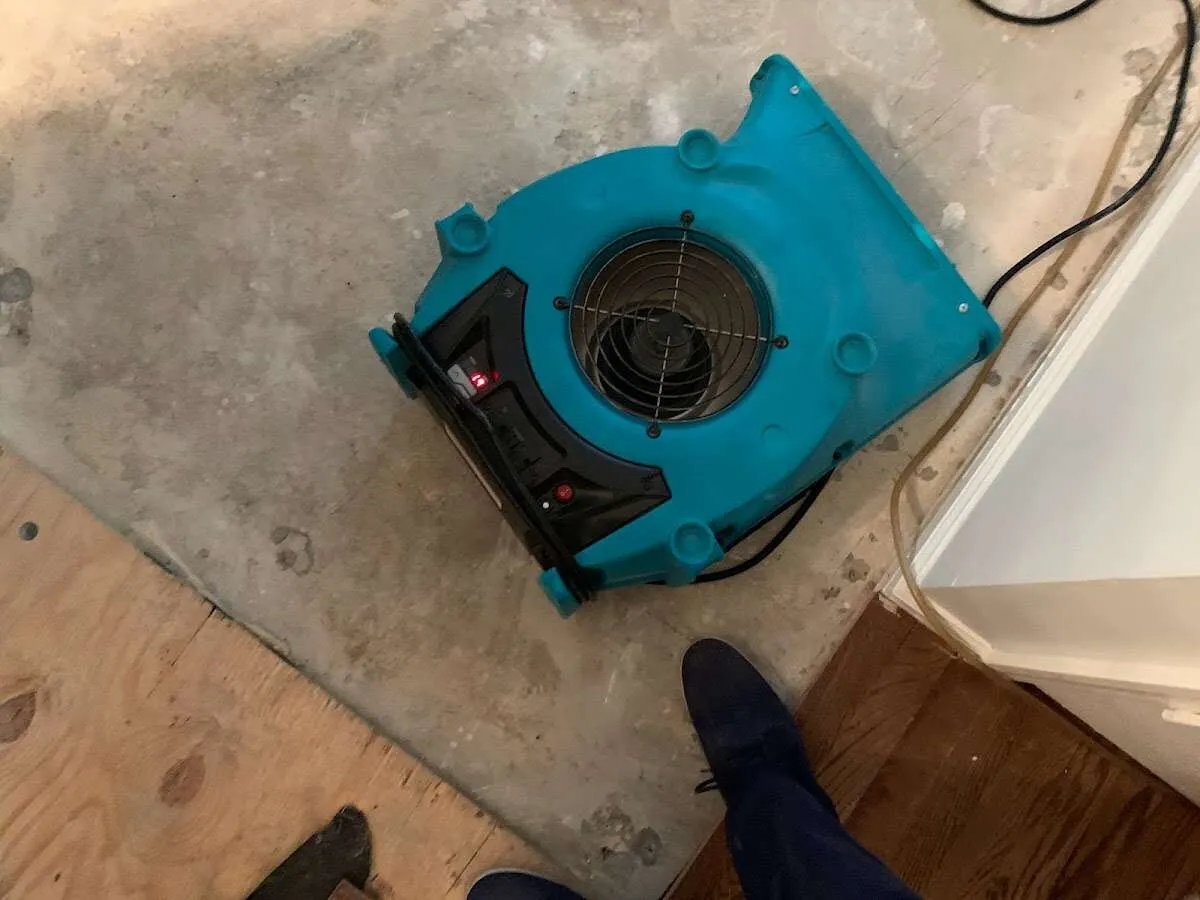 Air mover drying subfloor during Commercial Water Damage Restoration in Richland